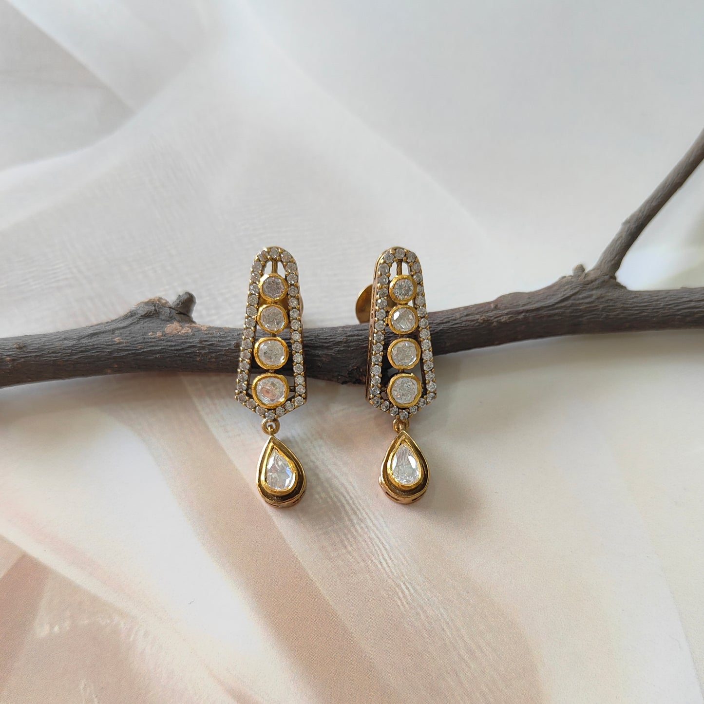 “Cascade of Light Earrings by ARKA Jaipur – handcrafted golden earrings with uncut polki diamonds and diamond pave border in sterling silver, luxury designer jewelry from Jaipur.”