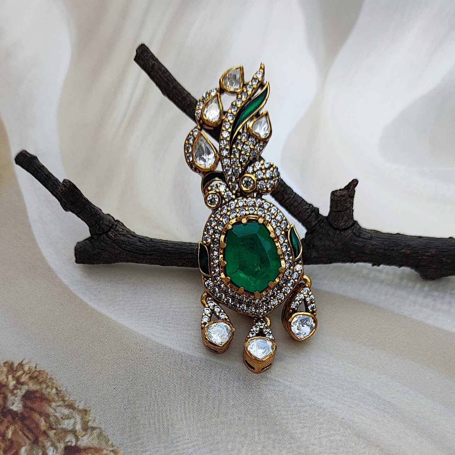 Emerald-Éclat ,Handcrafted emerald and polki diamond brooch by Arka Jaipur
Luxury designer brooch with oval emerald center and pavé diamond drop
Rajasthani heritage-inspired emerald polki brooch by Arka Jaipur
Gold and polki diamond brooch with emerald centerpiece and gemstone detailing