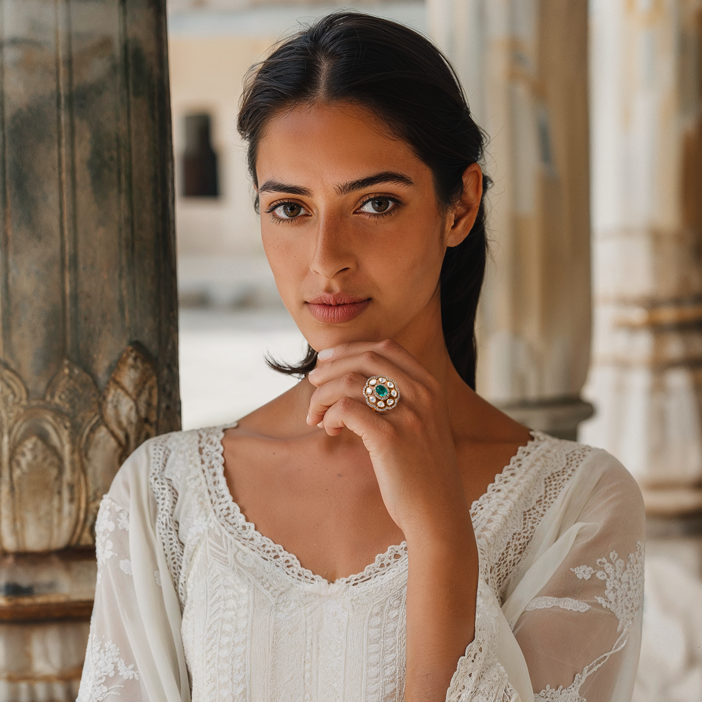 Inspired by divine femininity, the Hariti Ring by Arka Jaipur is a bold yet elegant statement piece. Crafted in radiant gold-tone finish, it features a central oval emerald framed by uncut Polki-style stones and a halo of fine crystals. This handcrafted ring evokes regal charm and traditional craftsmanship, perfect for festive, bridal, or high-fashion occasions.