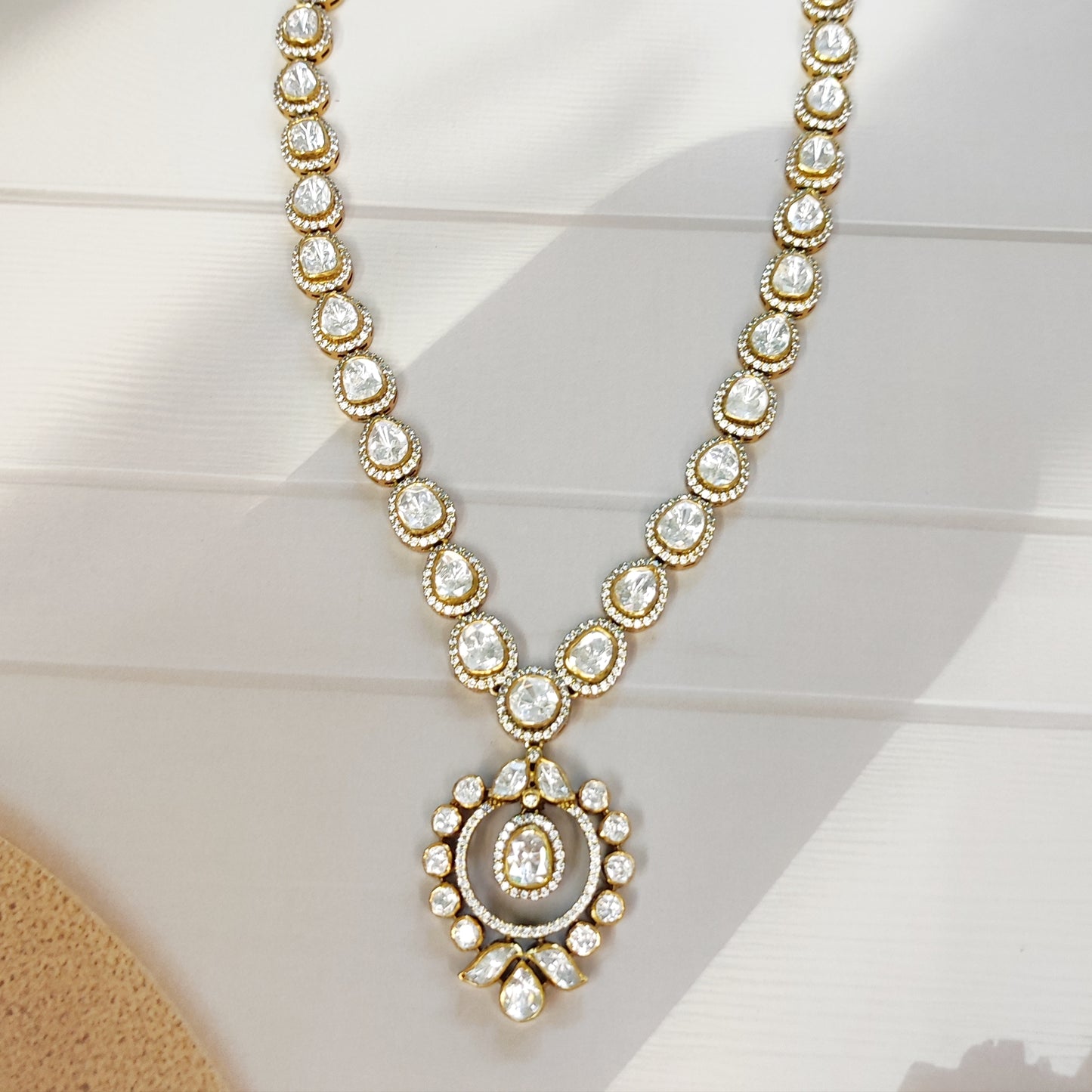 "Heritage Polki halo Necklace in gold polished silver with teardrop and round stons by Arka Jaipur","Traditional handcrafted Polki Necklace with CZ detailing from Arka Jaipur","Designer Indian Polki dangler earrings in circular halo design by Arka Jaipur"