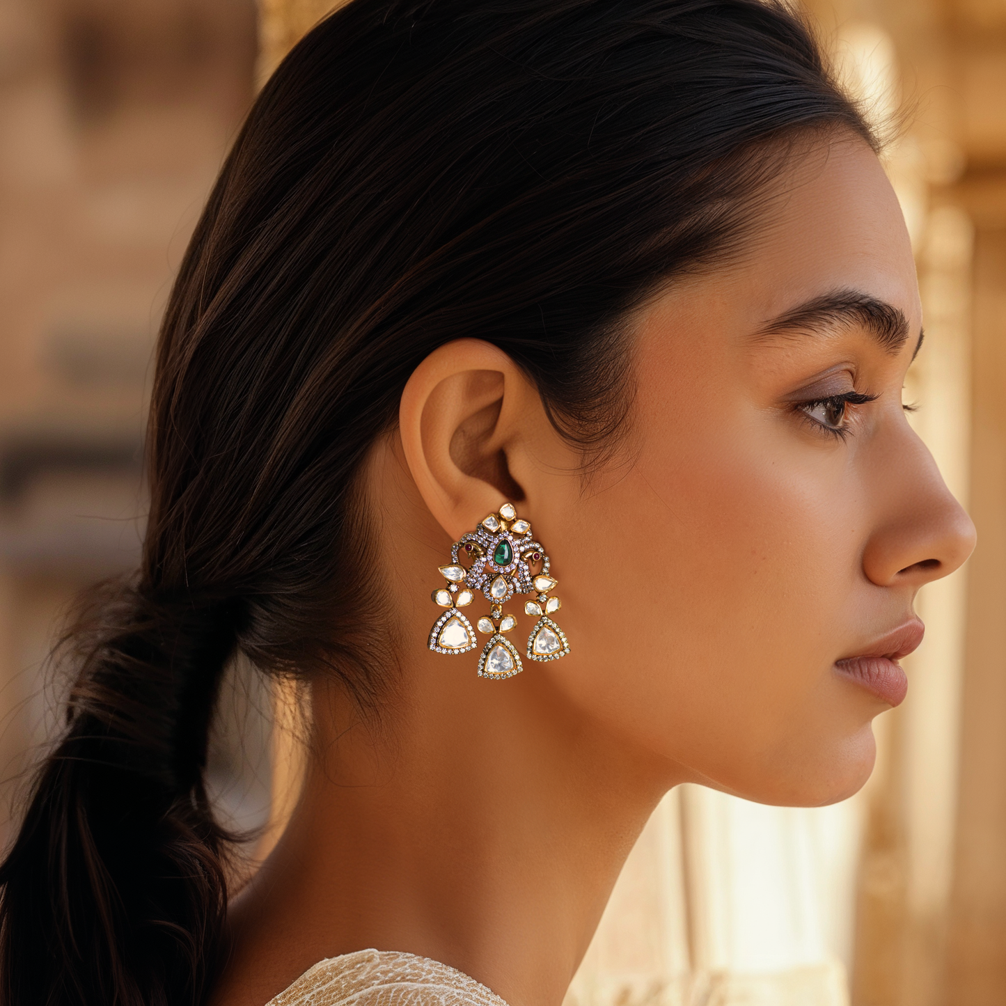 Mor Parikhan gold-plated chandelier earrings by Arka Jaipur featuring green stone center, moissanite embellishments, and peacock-inspired Indian design – ideal for bridal and festive wear.