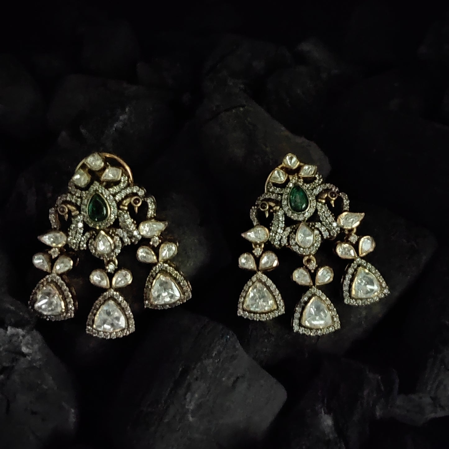 Mor Parikhan gold-plated chandelier earrings by Arka Jaipur featuring green stone center, moissanite embellishments, and peacock-inspired Indian design – ideal for bridal and festive wear.