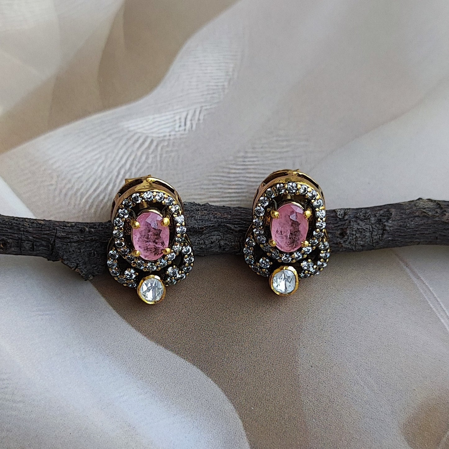 "Gold-plated Roséra earrings with pink oval gemstone and crystal halo by Arka Jaipur"
