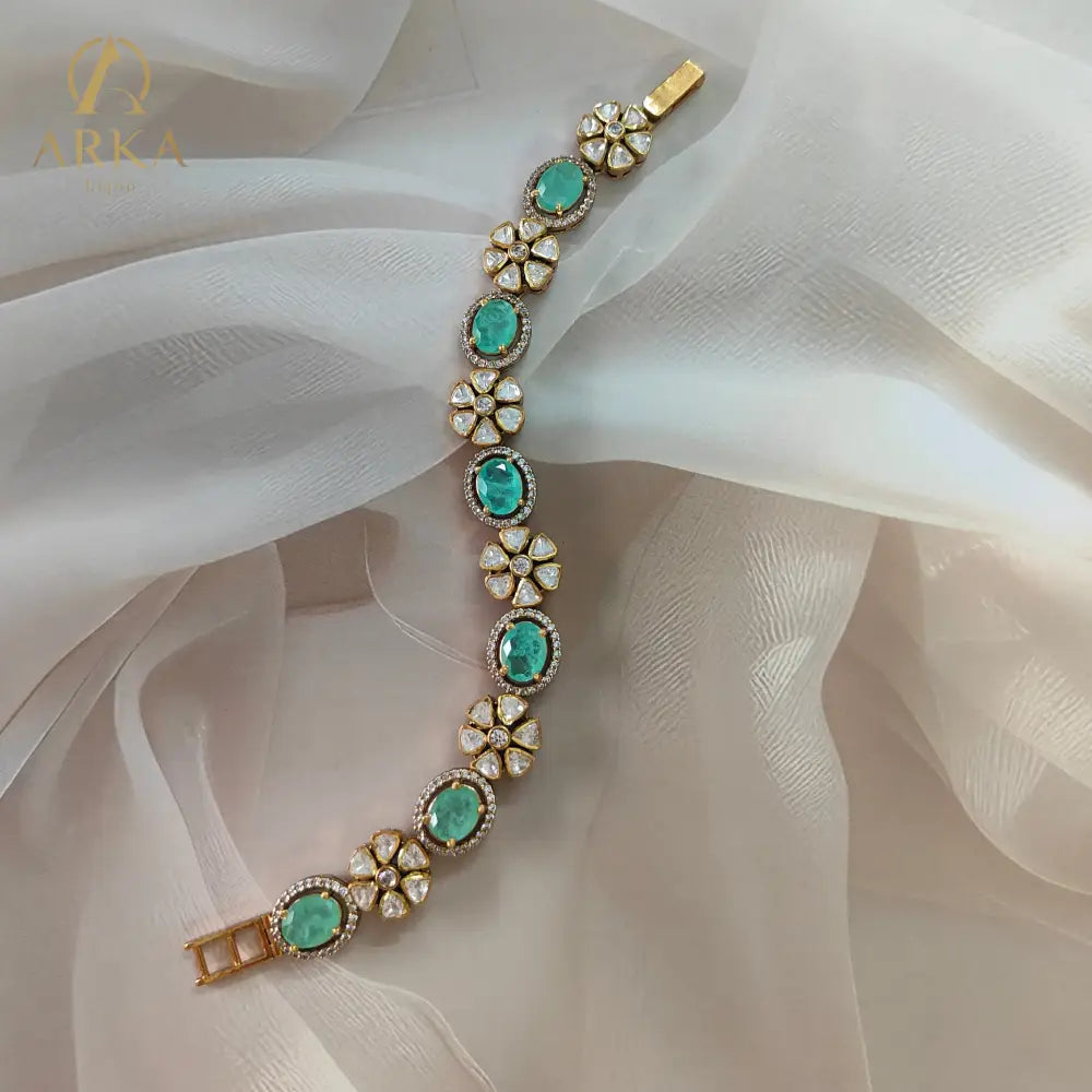 "Aureya Bracelet Bracelet Luxury emerald kundan floral bracelet by Arka Jaipur, handcrafted Indian jewelry with antique gold finish"