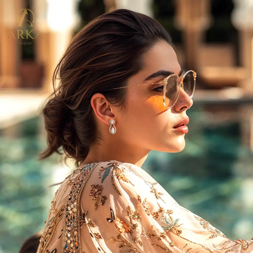 Arka_Jaipur_Dewdrop_Earrings_gold-plated_sterling_silver_earrings_featuring_pear-shaped_moissanite_stones_and_a_halo_of_crystals_designed_in_a_delicate_teardrop_silhouette.