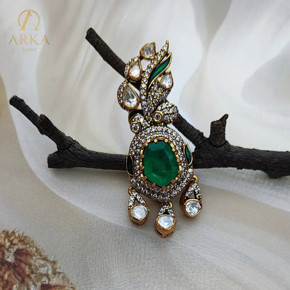Emerald-Éclat ,Handcrafted emerald and polki diamond brooch by Arka Jaipur
Luxury designer brooch with oval emerald center and pavé diamond drop
Rajasthani heritage-inspired emerald polki brooch by Arka Jaipur
Gold and polki diamond brooch with emerald centerpiece and gemstone detailing
