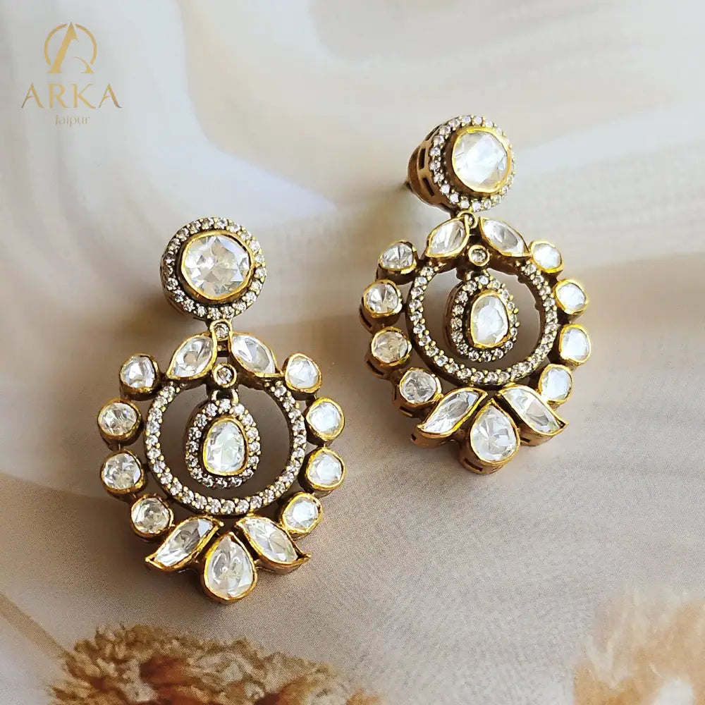 "Polki halo earrings in gold polished silver with teardrop and round stones by Arka Jaipur","Traditional handcrafted Polki earrings with CZ detailing from Arka Jaipur","Designer Indian Polki dangler earrings in circular halo design by Arka Jaipur"
