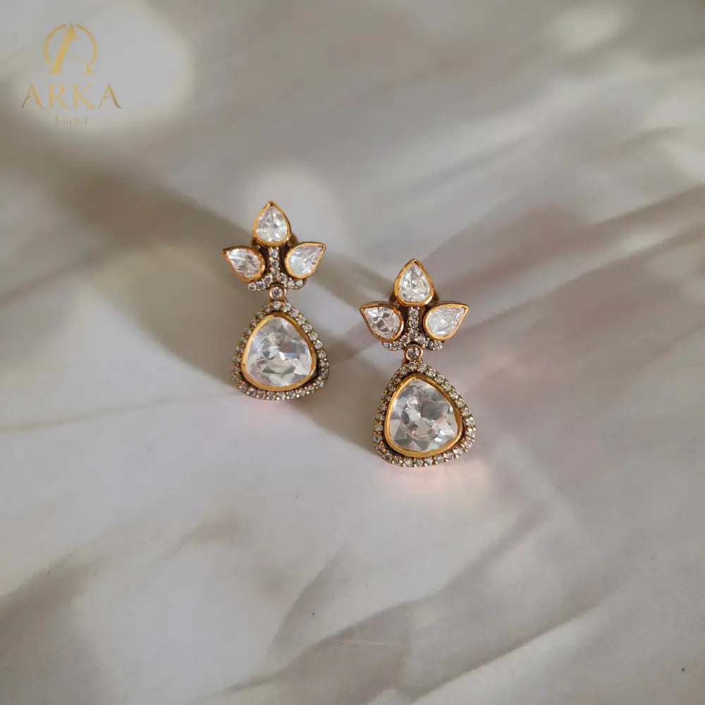 "Lotus Dewdrop Earrings by Arka Jaipur featuring uncut polki-style stones in lotus petal and teardrop shapes, antique gold finish with crystal accents, handcrafted Indian designer jewelry"