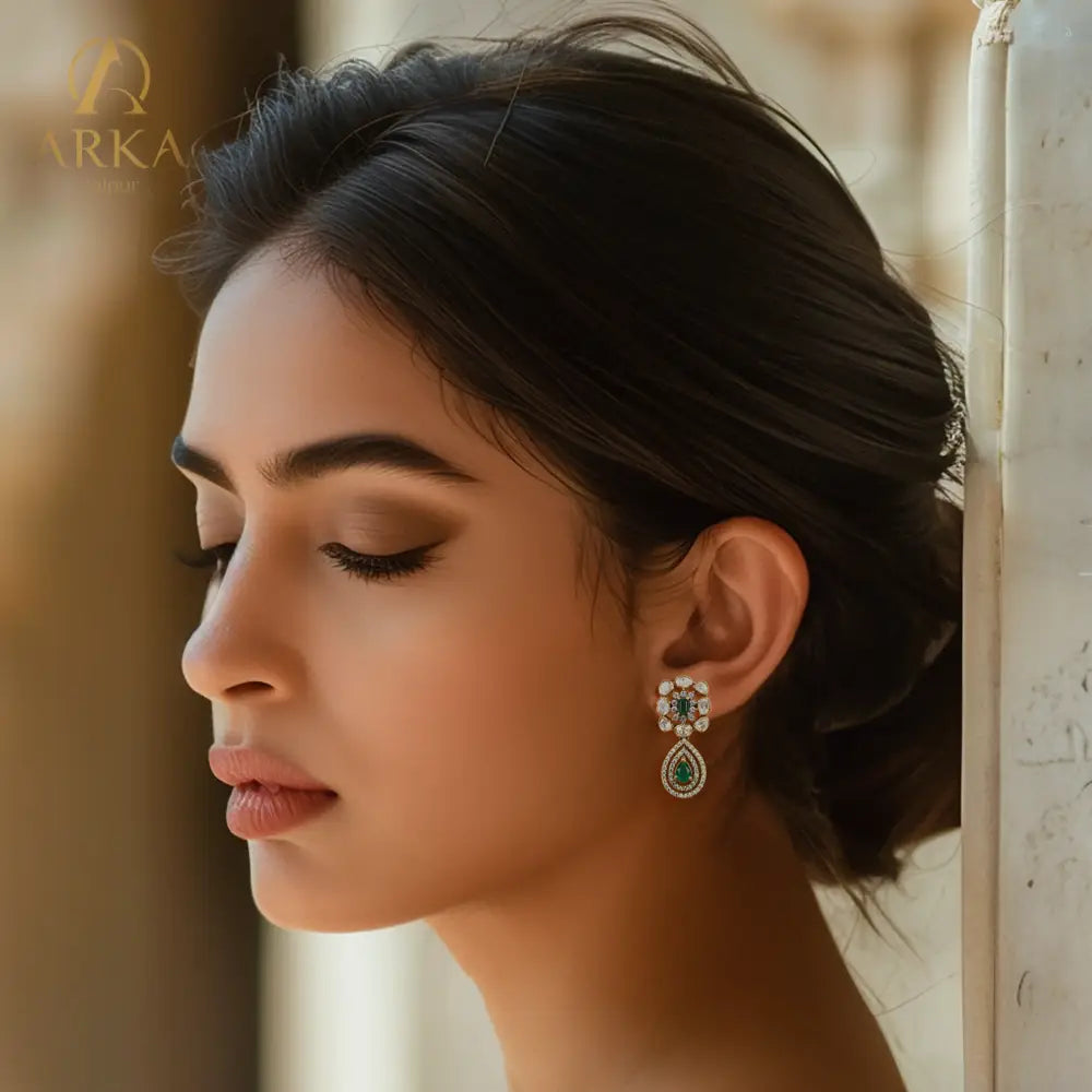 Arka Jaipur Panna Vilas emerald green and polki statement earrings with antique gold finish, teardrop design, and bridal jewelry styling