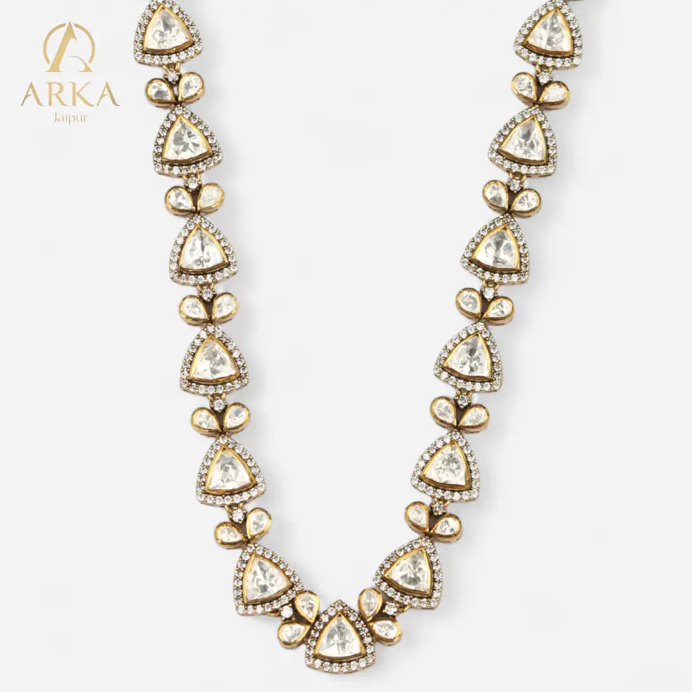 Petals of Paradise necklace by Arka Jaipur, showcasing triangular kundan-style stones bordered with white zircons and gold petal embellishments in a regal, handcrafted design.