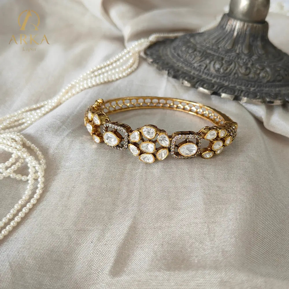 "Heritage polki floral gold-plated silver bangle with uncut stones by Arka Jaipur"