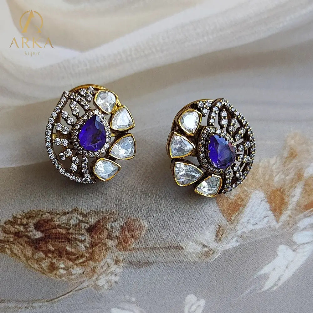 "Arka Jaipur gold-plated Veloura earrings with violet gemstone, surrounded by polki stones and crystal halo, luxe statement stud earrings, traditional Indian jewelry"