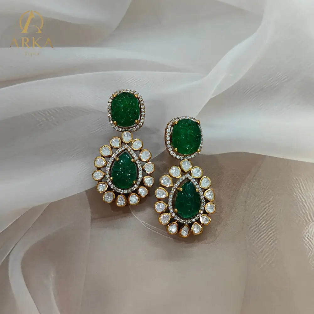 "Arka Jaipur Vintage Emerald Charm handcrafted Earrings with carved emerald green stones, Polki diamond halo, and gold finish – heritage inspired statement jewelry."