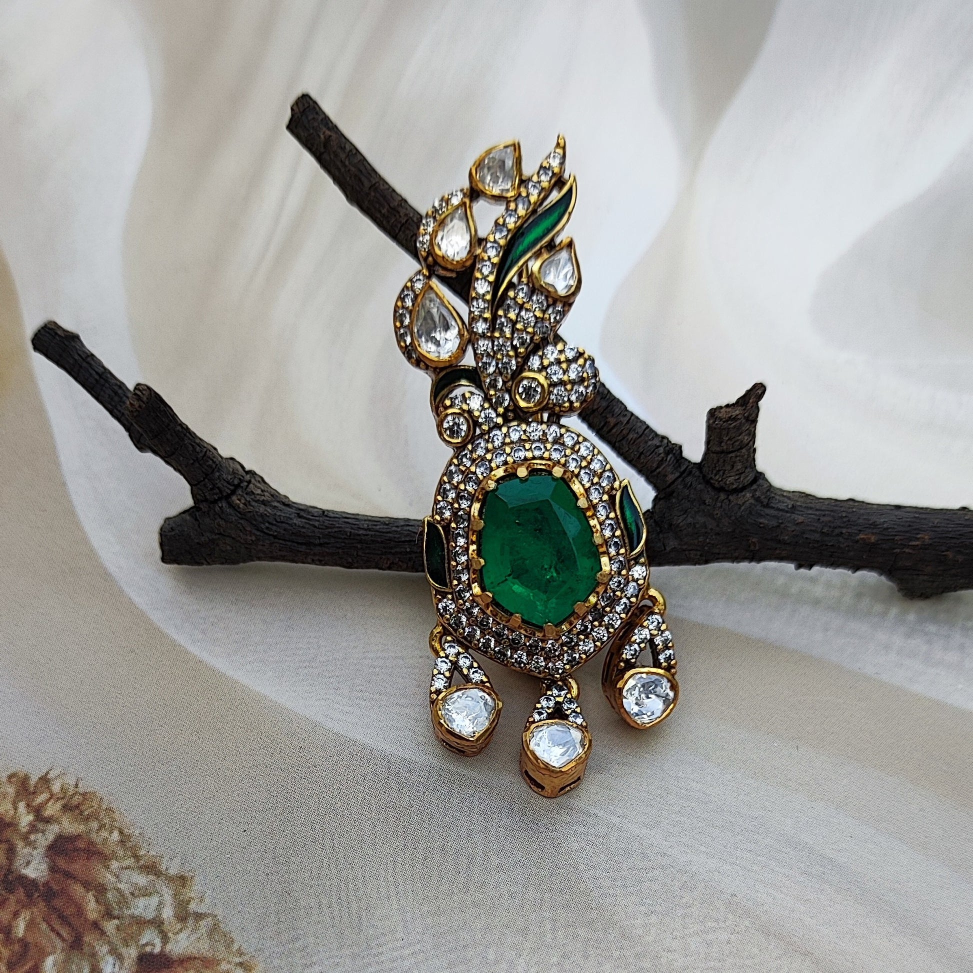 Emerald-Éclat ,Handcrafted emerald and polki diamond brooch by Arka Jaipur

Luxury designer brooch with oval emerald center and pavé diamond drop

Rajasthani heritage-inspired emerald polki brooch by Arka Jaipur

Gold and polki diamond brooch with emerald centerpiece and gemstone detailing