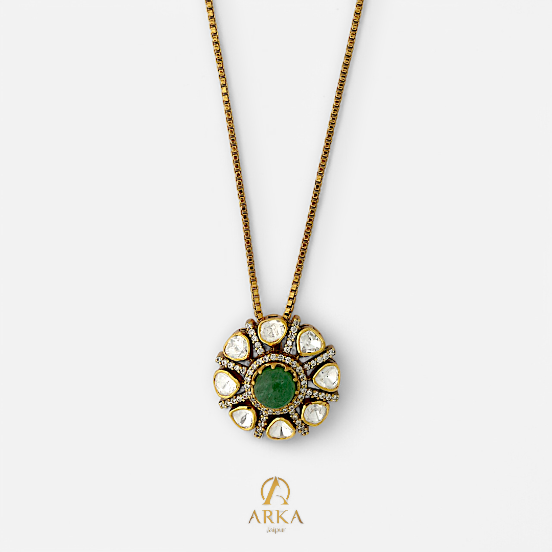 Emerald Sunburst Pendant by Arka Jaipur, handcrafted 925 sterling silver jewelry with central green emerald and surrounding polki stones on gold finish chain.