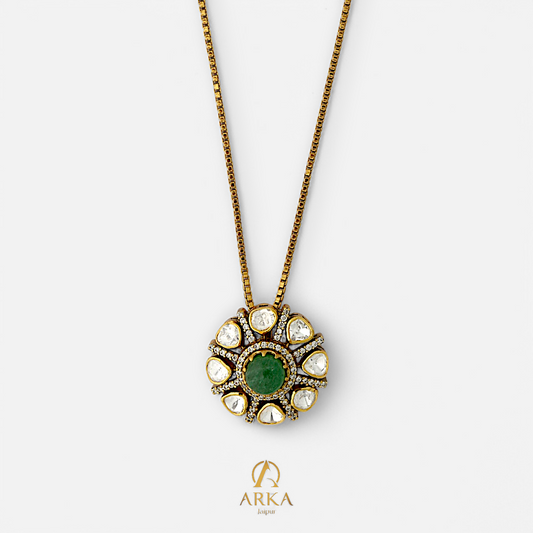 Emerald Sunburst Pendant by Arka Jaipur, handcrafted 925 sterling silver jewelry with central green emerald and surrounding polki stones on gold finish chain.