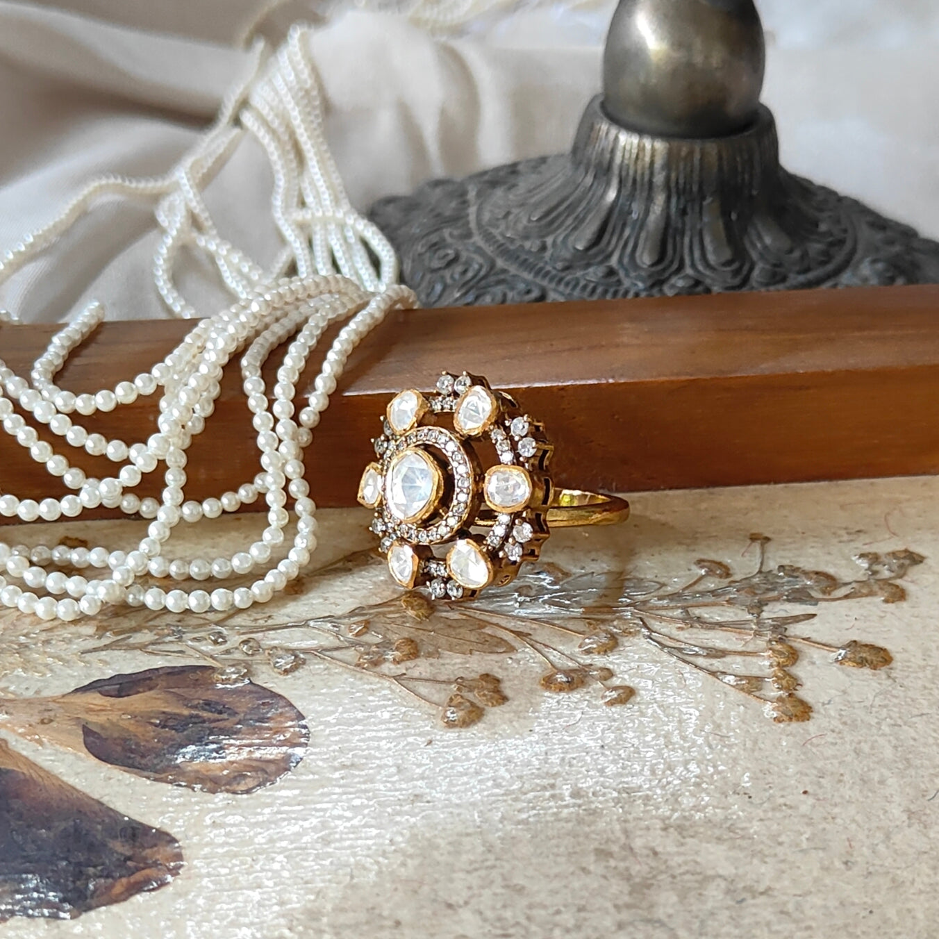 “Eternal Blossom Ring by Arka Jaipur featuring uncut Polki stones, teardrop centre, crystal halo, and gold-tone floral design"