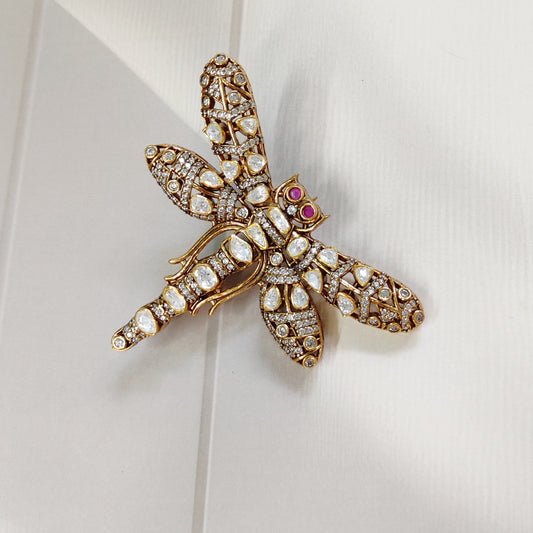Handcrafted dragonfly brooch with uncut polki diamonds and ruby eyes by Arka Jaipur

Luxury gold dragonfly brooch inspired by Rajasthani architecture

Designer statement polki diamond brooch by Arka Jaipur

Heritage-inspired dragonfly jewelry brooch with rubies and polki
