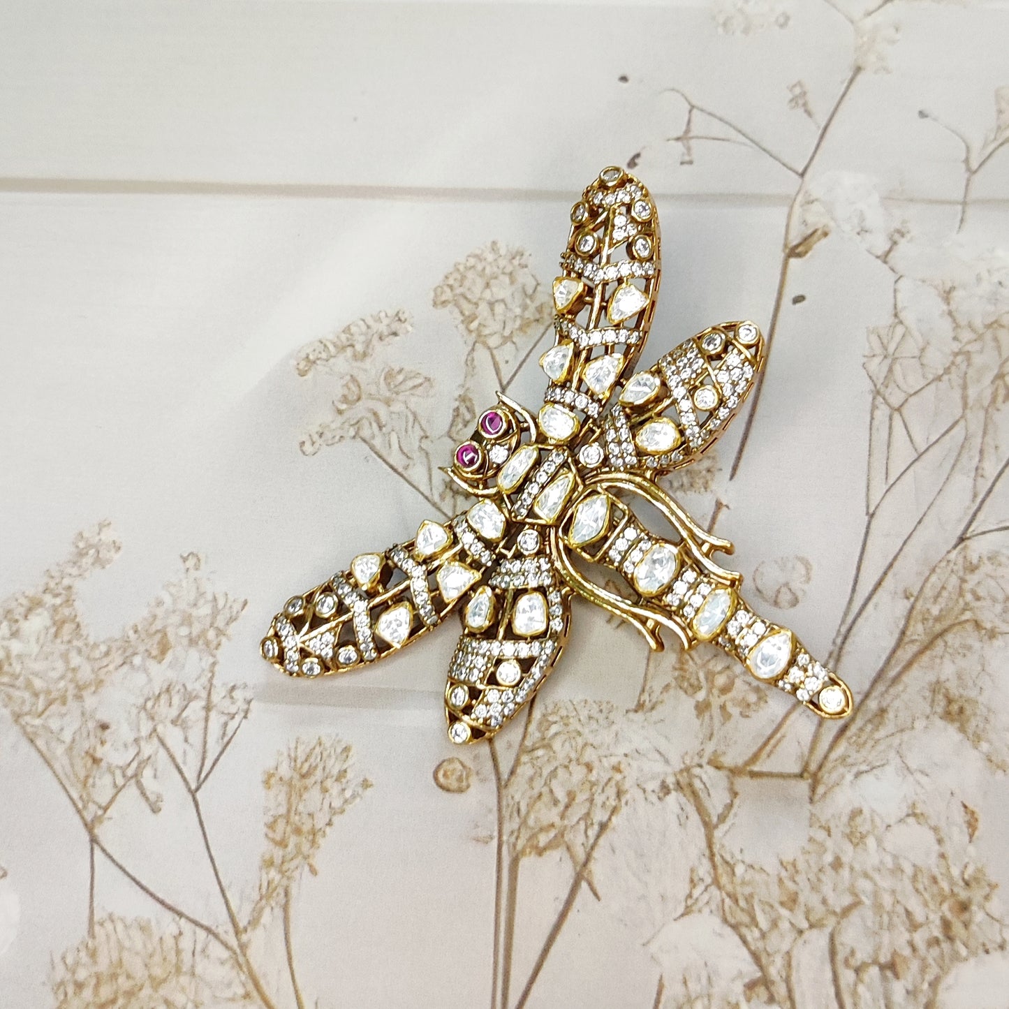 Handcrafted dragonfly brooch with uncut polki diamonds and ruby eyes by Arka Jaipur

Luxury gold dragonfly brooch inspired by Rajasthani architecture

Designer statement polki diamond brooch by Arka Jaipur

Heritage-inspired dragonfly jewelry brooch with rubies and polki
