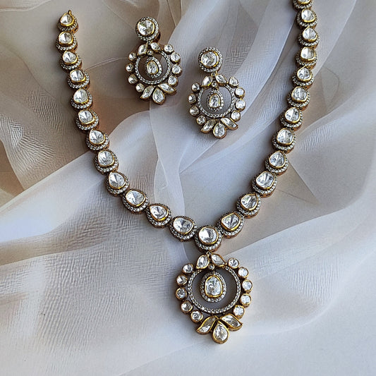 "Polki halo earrings in gold polished silver with teardrop and round stones by Arka Jaipur","Traditional handcrafted Heritage Polki Halo Necklace set with  earrings with CZ detailing from Arka Jaipur","Designer Indian Polki dangler earrings in circular halo design by Arka Jaipur"