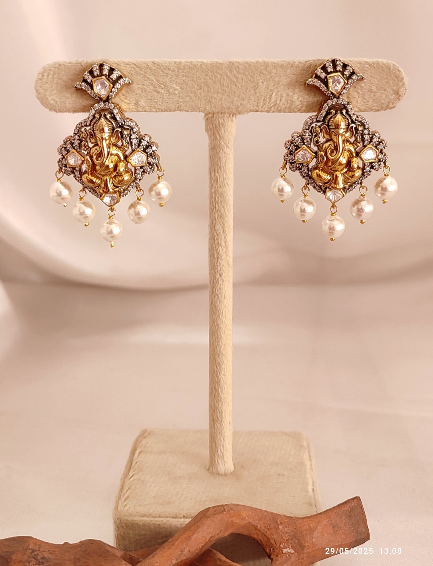 Iraj matching earrings with Lord Ganesha motif, antique gold earrings with pearl drops, traditional Indian temple jewellery for festive and ethnic wear