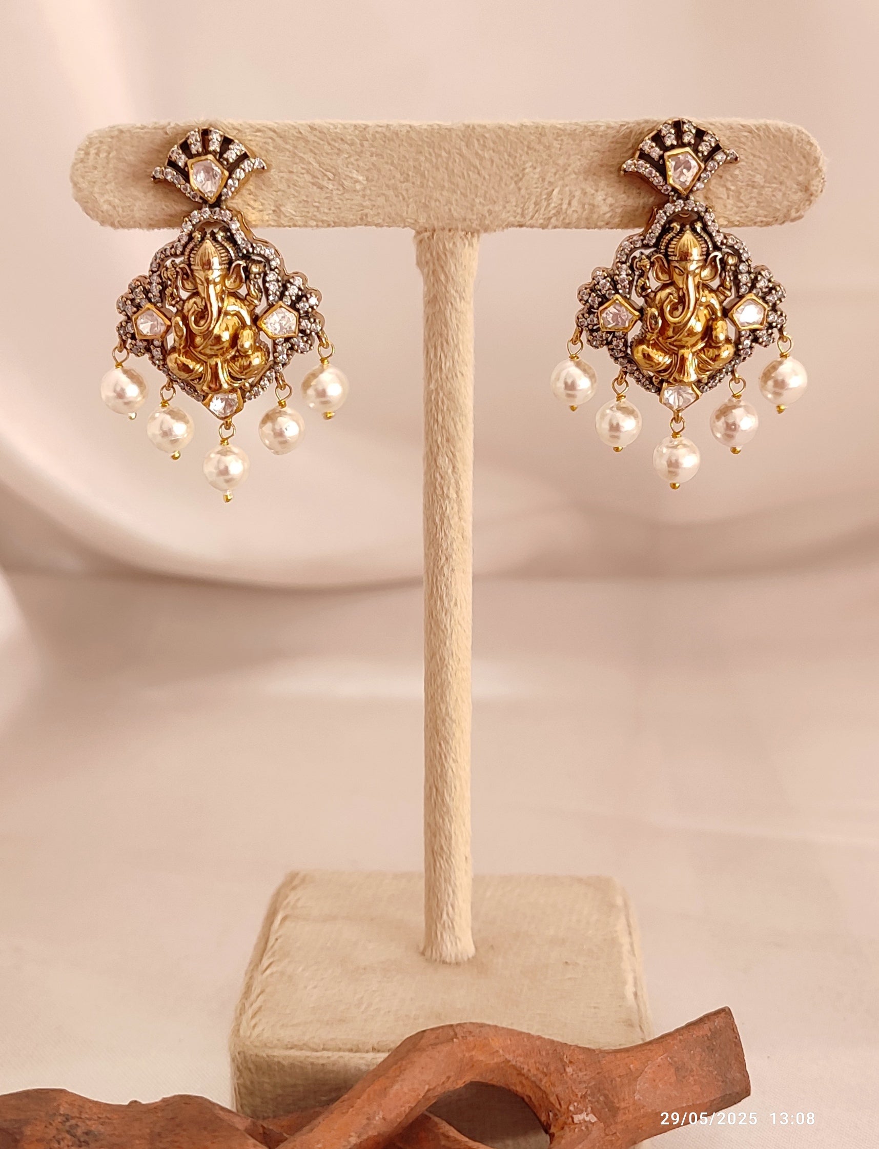Iraj matching earrings with Lord Ganesha motif, antique gold earrings with pearl drops, traditional Indian temple jewellery for festive and ethnic wear