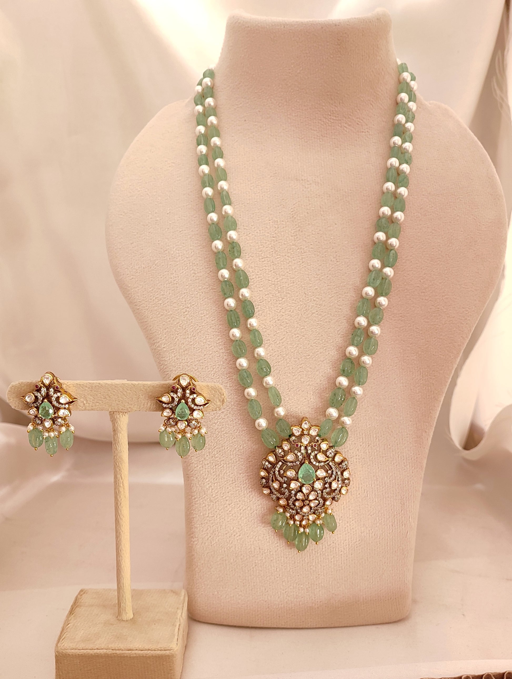 Meher-e-Panna silver jewelry set with green stones and pearls