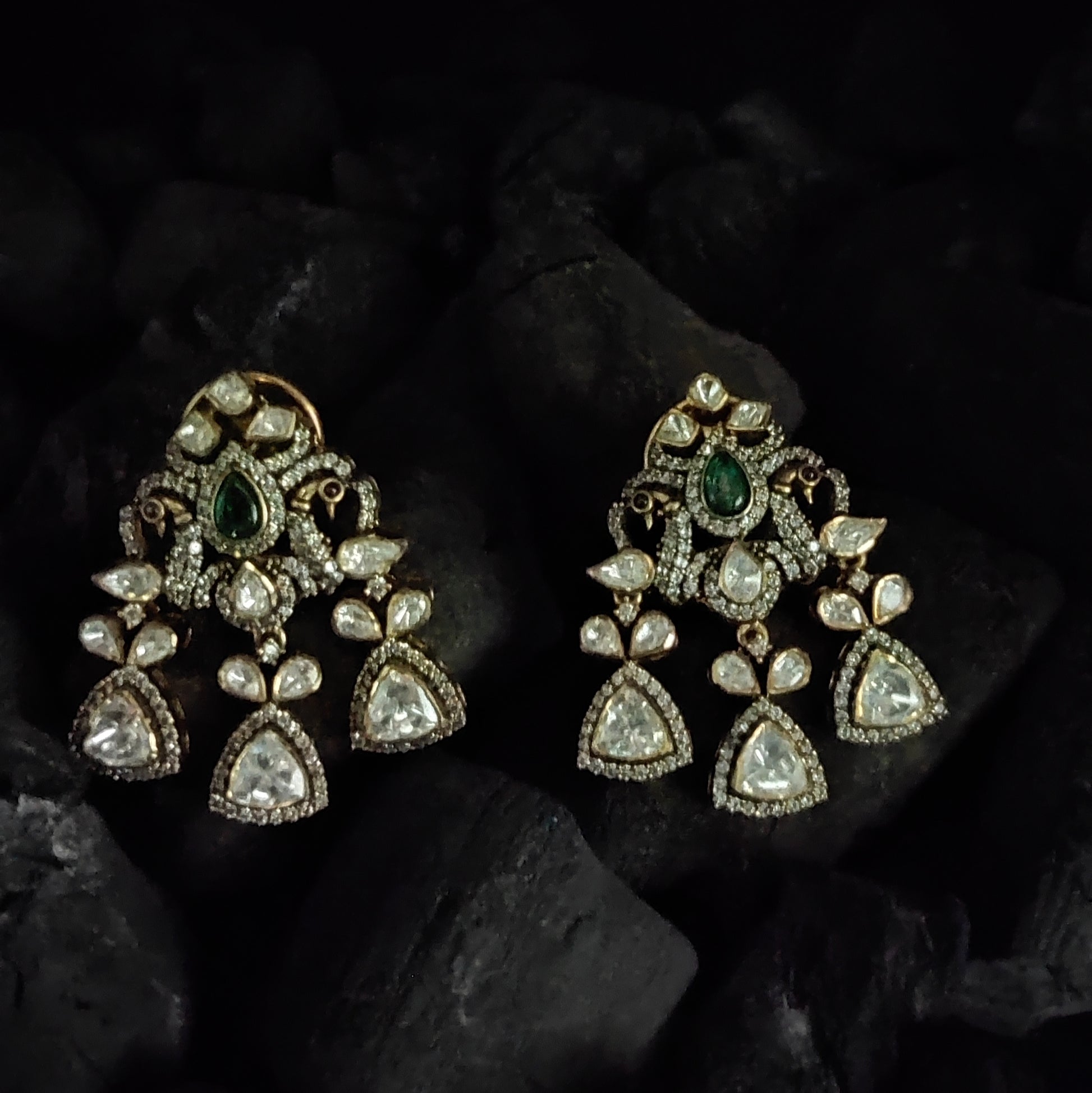 Mor Parikhan gold-plated chandelier earrings by Arka Jaipur featuring green stone center, moissanite embellishments, and peacock-inspired Indian design – ideal for bridal and festive wear.