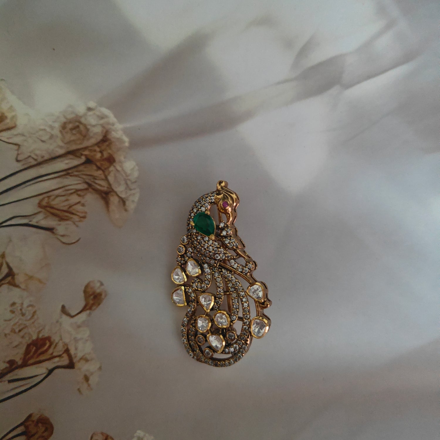Rajwada Peacock Grace,Handcrafted peacock-inspired brooch with emerald and polki diamonds by Arka Jaipur

Luxury designer peacock brooch in gold with emerald gemstone and diamond detailing

Heritage-inspired polki and emerald brooch by Arka Jaipur

Exquisite peacock motif brooch with emerald centerpiece and pavé diamonds
