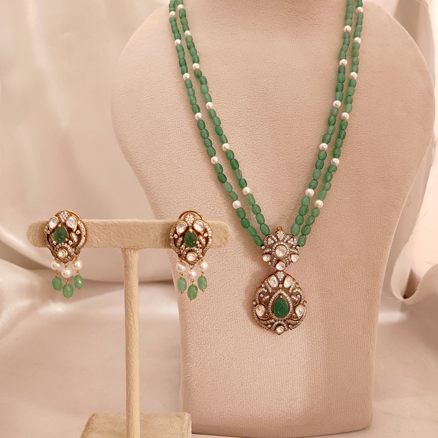 “Sanjh Emerald Set by Arka Jaipur featuring emerald-green stones, crystal accents, and intricate gold detailing in an elegant traditional jewellery design.”