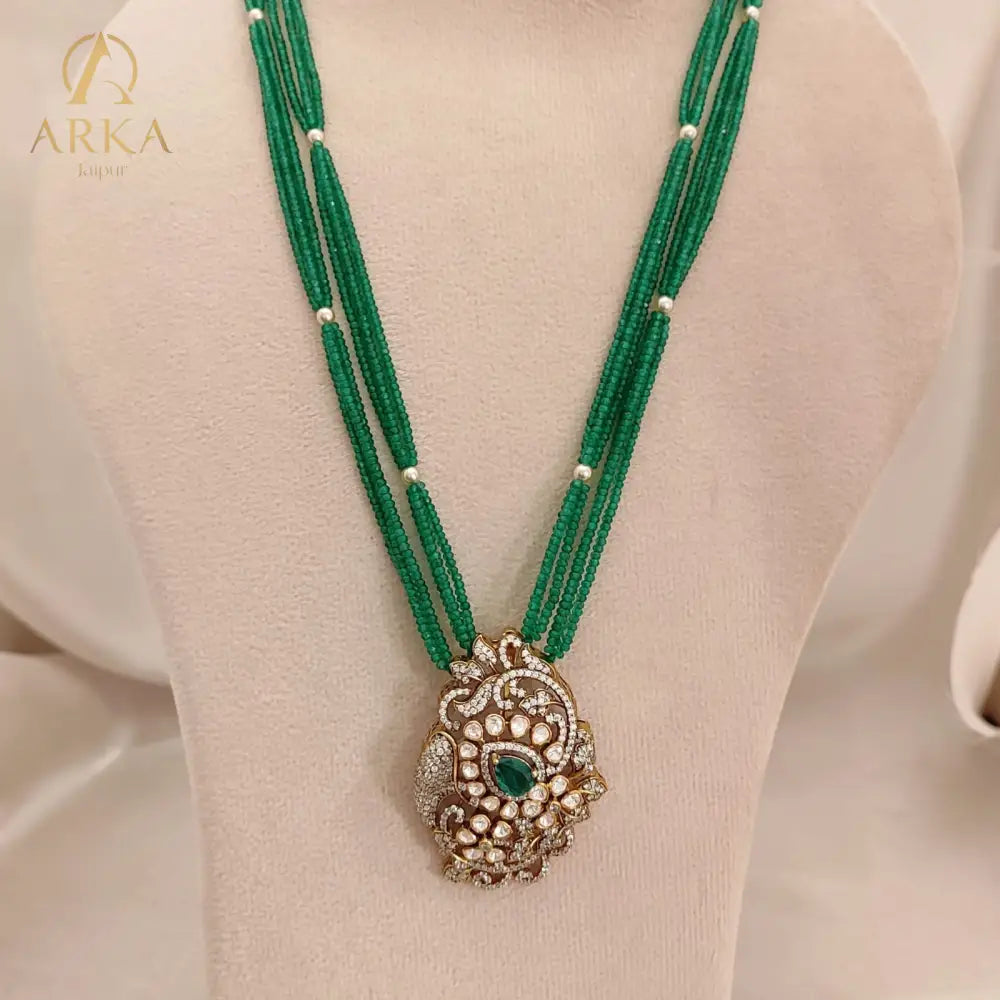 Seren Verde Necklace Set — elegant woman wearing Arka Jaipur’s handcrafted contemporary emerald and gold necklace, featuring multi-strand green beads and a modern pendant, perfect for festive or luxury occasions.
