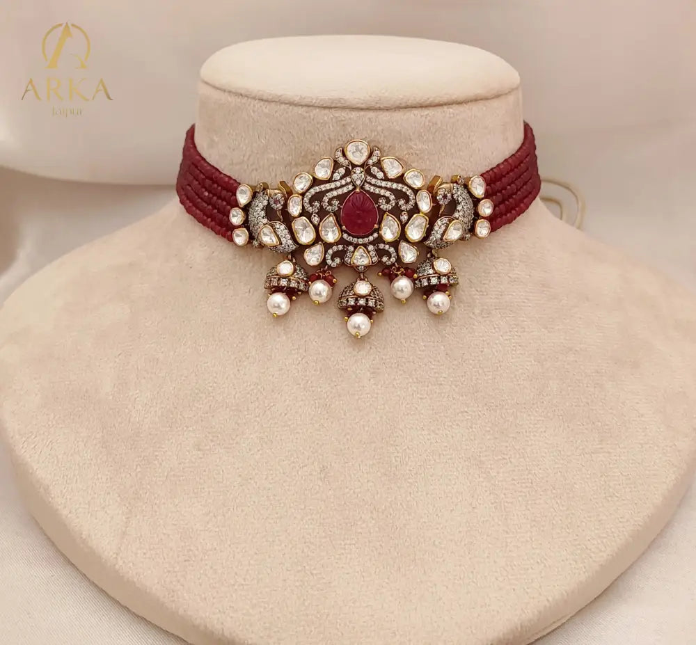 Crimson Vogue Set by Arka Jaipur featuring ruby kundan drop earrings and a maroon thread choker with pearl and stone embellishments, styled for pre-wedding celebrations.