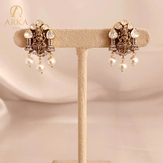 Devi Earrings | Moissanite & Pearl Antique Gold coloure Earrings by Arka Jaipur, handcrafted antique gold coloured earrings with moissanite, CZ diamonds, and pearl drops. A perfect blend of tradition and elegance for festive and wedding wear.
