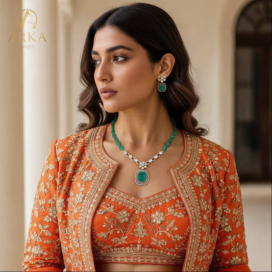 "Emerald Blossom Set necklace and earring set by Arka Jaipur featuring floral crystal designs and central green stone pendant – traditional Indian jewelry set"