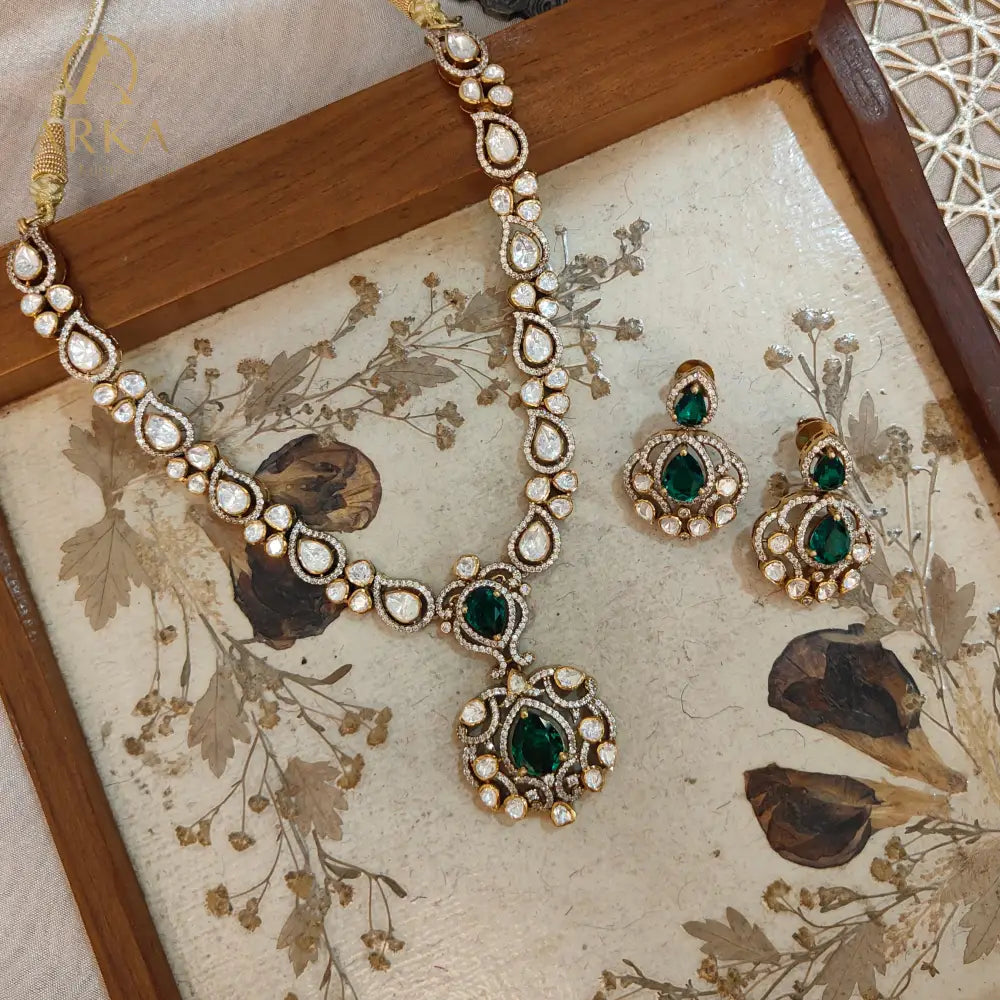 Arka Jaipur emerald green kundan polki necklace set with matching earrings in sterling silver”

“Designer Indian bridal jewelry set with emerald stones and polki kundan work by Arka Jaipur”

“Luxury sterling silver necklace and earrings with emerald green accents and kundan detailing”

“Traditional Indian bridal emerald kundan polki jewelry set by Arka Jaipur”
