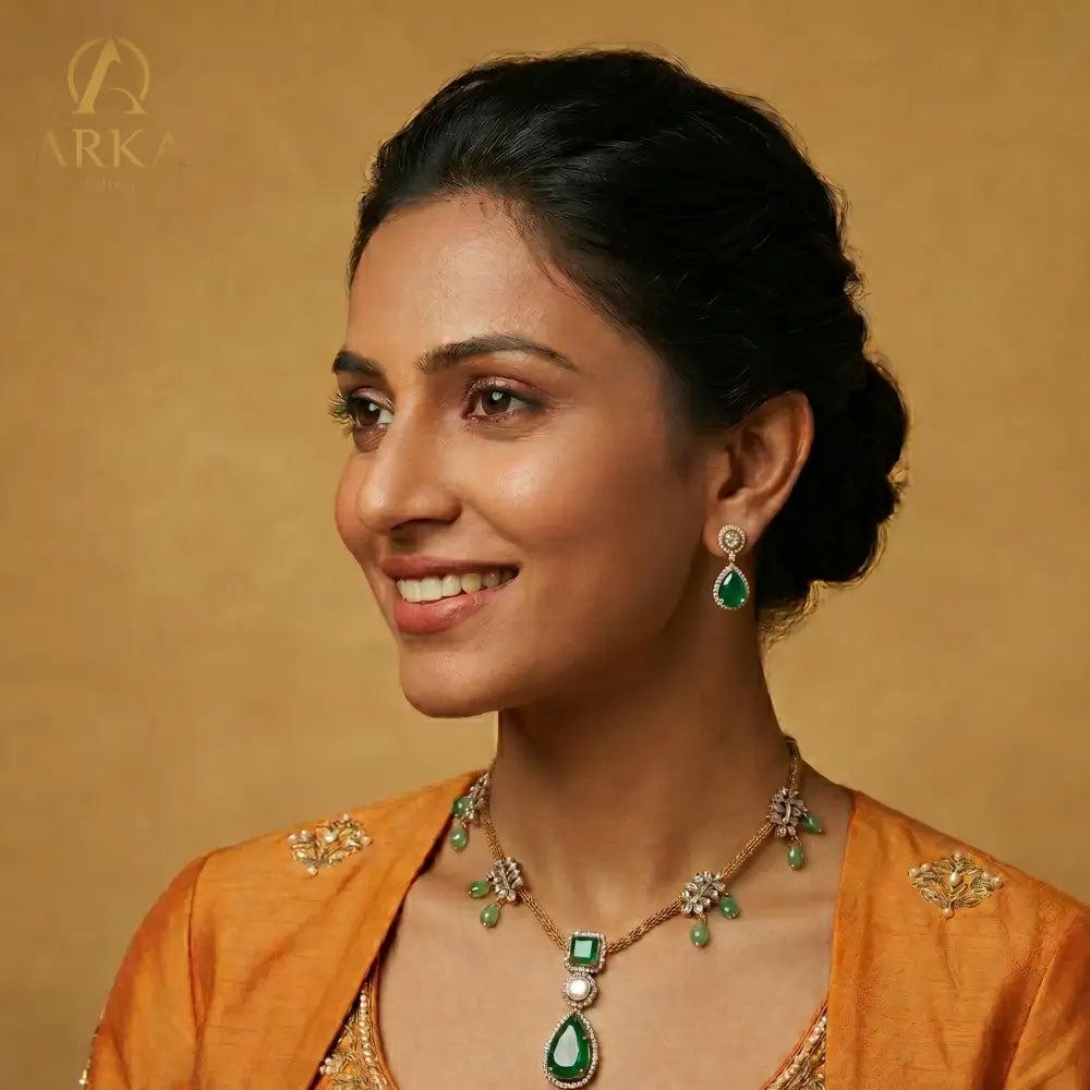 Emerald green sterling silver  Emerald Reverie Necklace and earring set with polki detailing and antique gold finish by Arka Jaipur.