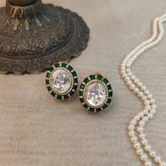 "Arka Jaipurs Eterna handcrafted  Polki stud earrings with oval center stone, emerald-green halo, diamond accents, and gold-plated finish – heritage luxury jewelry."