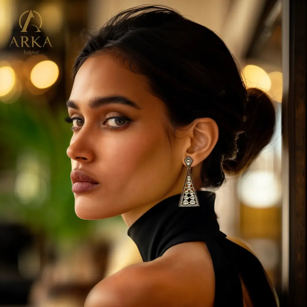 Geometric Grace earrings by Arka Jaipur – triangular moissanite-studded silver earrings with gold and enamel detailing.