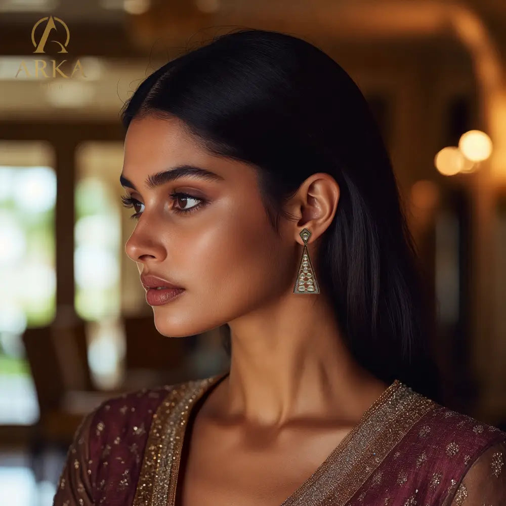 Geometric Grace earrings by Arka Jaipur – triangular moissanite-studded silver earrings with gold and enamel detailing.