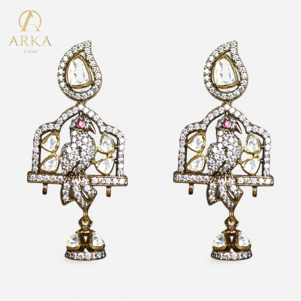 “Majestic Aviary Drops Earrings by Arka Jaipur – designer statement earrings with diamond-studded bird motif, polki stones, jharokha-inspired arch, and gold finish dangler design.”
