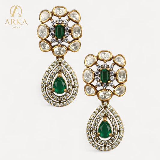 Arka Jaipur Panna Vilas emerald green and polki statement earrings with antique gold finish, teardrop design, and bridal jewelry styling