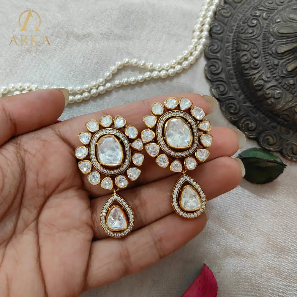 "Arka Jaipur handcrafted Polki Radiance earrings with central uncut diamond-look stones, halo design, teardrop drops, and gold finish – royal heritage jewelry."