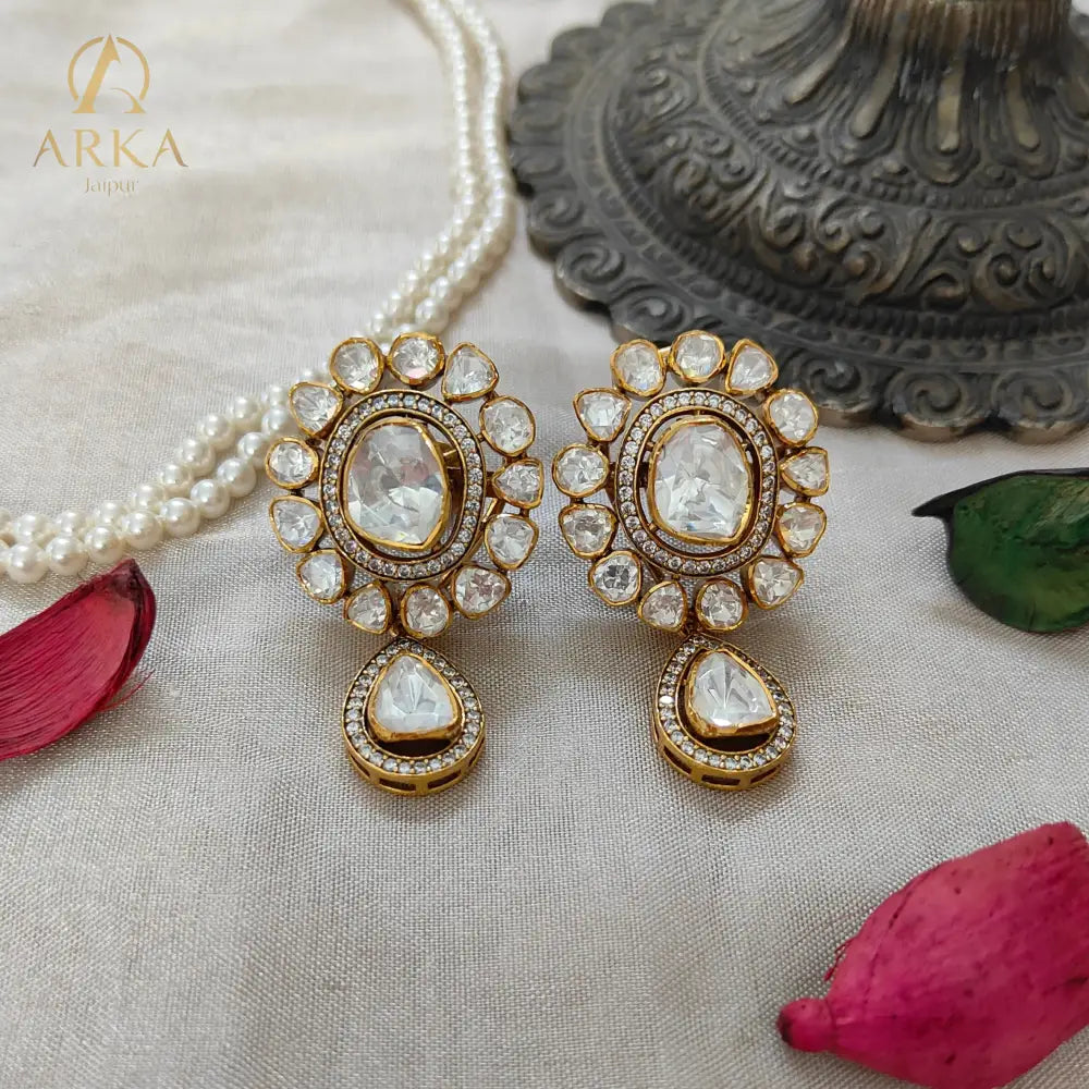 "Arka Jaipur handcrafted Polki Radiance earrings with central uncut diamond-look stones, halo design, teardrop drops, and gold finish – royal heritage jewelry."