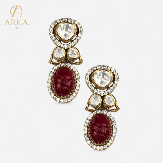 Regal_Ruby_earrings_by_Arka_Jaipur_gold-plated_silver_earrings_featuring_hand-carved_ruby_red_stones_and_moissanite_polki_bordered_with_sparkling_CZ_diamonds.