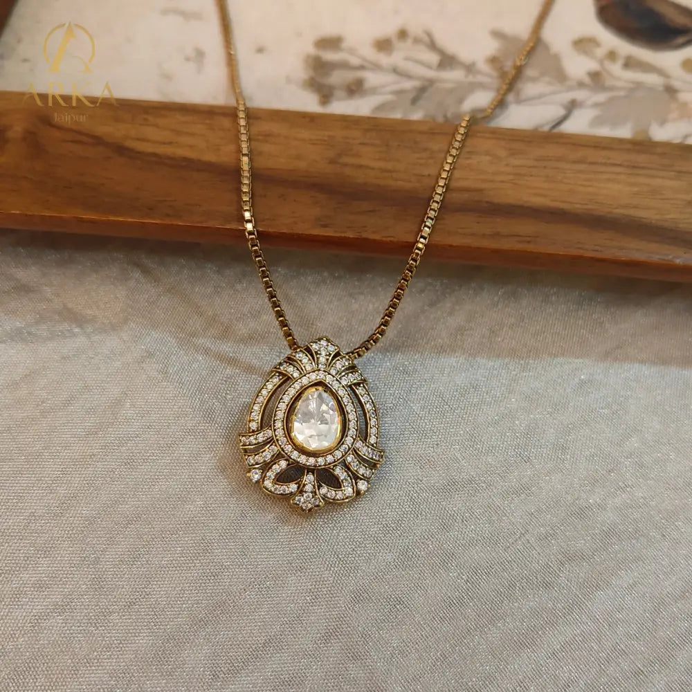 "Regal teardrop moissanite pendant in gold-plated silver by Arka Jaipur, heritage-inspired designer jewelry for weddings and festive occasions"