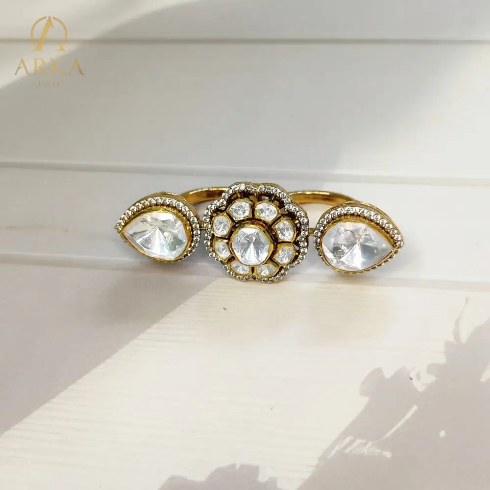 “Twin Bloom Ring by Arka Jaipur featuring a central floral polki design with two teardrop crystal motifs on each side, set in a gold finish, photographed on a soft neutral background with natural light.”