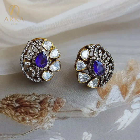 "Arka Jaipur gold-plated Veloura earrings with violet gemstone, surrounded by polki stones and crystal halo, luxe statement stud earrings, traditional Indian jewelry"