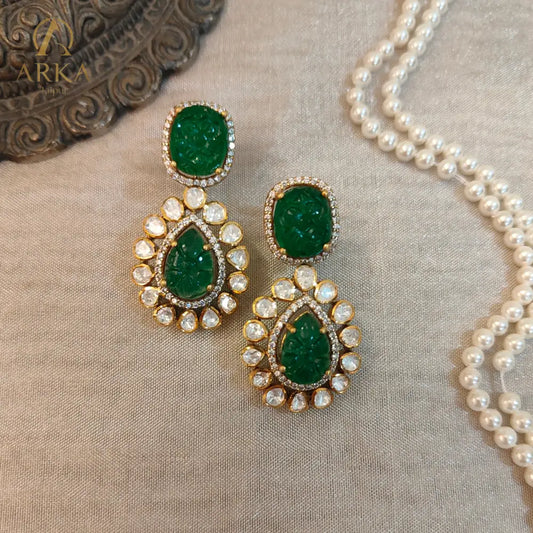 "Arka Jaipur Vintage Emerald Charm handcrafted Earrings with carved emerald green stones, Polki diamond halo, and gold finish – heritage inspired statement jewelry."