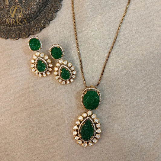 "Arka Jaipur Vintage Emerald Charm handcrafted Pendant Set with carved emerald green stones, Polki diamond halo, and gold finish – heritage inspired statement jewelry."